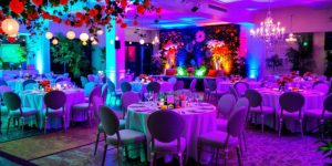 Colorful event setup with tables and decorations.