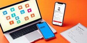 Laptop and smartphone with social media icons for business.