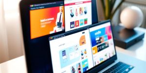 Laptop displaying various shopping websites.
