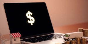 Laptop with money and small business tools.